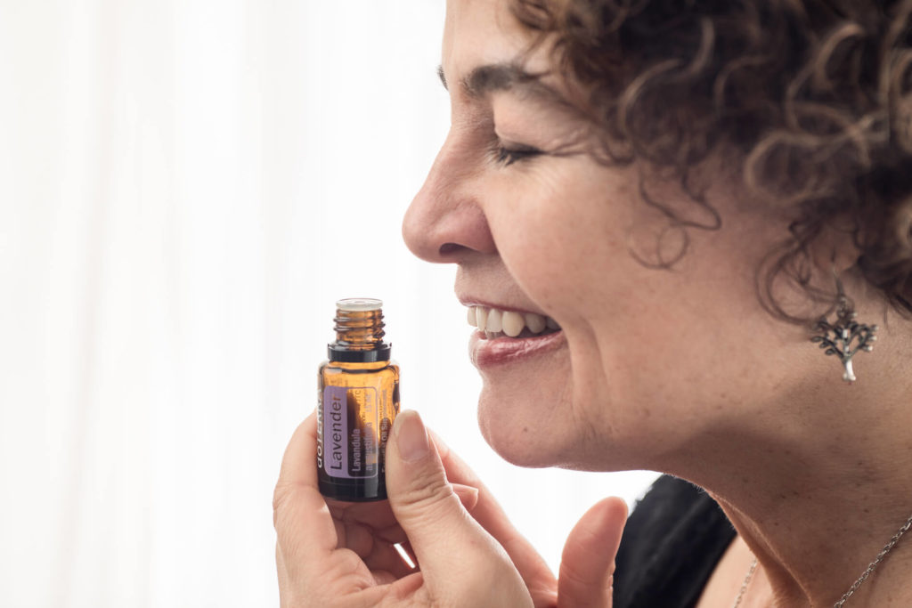 woman smelling do terra essential oils in photo session